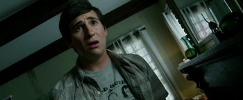 Movie still from “Project Almanac” (2015), directed by Dean Israelite – A young man in a gray shirt and a plaid shirt; Close Up shot, Over the shoulder angle