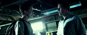 Movie still from “Project Almanac” (2015), directed by Dean Israelite – Two men are standing in a room talking to each other; Close Up shot, Low angle