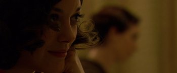 Movie still from “Public Enemies” (2009), directed by Michael Mann – A woman's face with a blurry background; Close Up shot, Over the shoulder angle