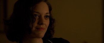 Movie still from “Public Enemies” (2009), directed by Michael Mann – A woman's face in a dark room; Close Up shot, Over the shoulder angle