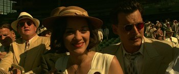 Movie still from “Public Enemies” (2009), directed by Michael Mann – A woman wearing a brown hat and a white dress; Close Up shot, High angle