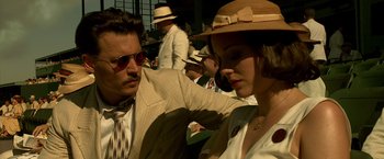 Movie still from “Public Enemies” (2009), directed by Michael Mann – A man and a woman in suits and hats; Close Up shot, Over the shoulder angle