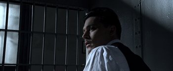 Movie still from “Public Enemies” (2009), directed by Michael Mann – A man standing in front of a jail cell; Close Up shot, Low angle