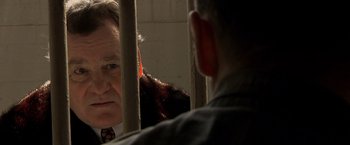 Movie still from “Public Enemies” (2009), directed by Michael Mann – A man looking at another man in a jail cell; Close Up shot, Over the shoulder angle