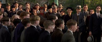 Movie still from “Public Enemies” (2009), directed by Michael Mann – A group of men and women wearing hats and suits; Medium shot, High angle
