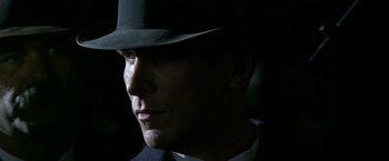 Movie still from “Public Enemies” (2009), directed by Michael Mann – A person wearing a hat; Close Up shot, Low angle