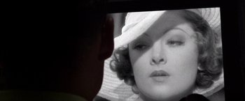 Movie still from “Public Enemies” (2009), directed by Michael Mann – A woman's face in a mirror; Extreme Close Up shot, Over the shoulder angle