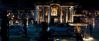 Movie still from “Punisher: War Zone” (2008), directed by Lexi Alexander – A night time picture of a building with a car parked in front of it; Extreme Wide shot, Low angle