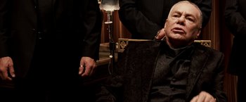 Movie still from “Punisher: War Zone” (2008), directed by Lexi Alexander – A man getting his hair cut at a barber shop; Close Up shot, Low angle