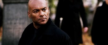 Movie still from “Punisher: War Zone” (2008), directed by Lexi Alexander – A man in a black shirt is looking at the camera; Close Up shot, Low angle