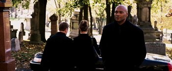 Movie still from “Punisher: War Zone” (2008), directed by Lexi Alexander – A man and two women walking in a cemetery; Medium shot, Over the shoulder angle