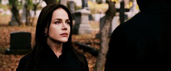 Movie still from “Punisher: War Zone” (2008), directed by Lexi Alexander – A woman standing in front of a tree in a cemetery; Close Up shot, Over the shoulder angle