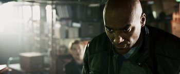 Movie still from “Punisher: War Zone” (2008), directed by Lexi Alexander – A person wearing a green jacket; Close Up shot, Over the shoulder angle