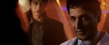 Movie still from “Punisher: War Zone” (2008), directed by Lexi Alexander – Two men are standing next to each other in a room; Close Up shot, Over the shoulder angle