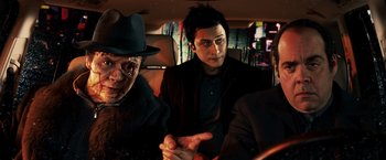 Movie still from “Punisher: War Zone” (2008), directed by Lexi Alexander – A group of people sitting in a car; Close Up shot, High angle