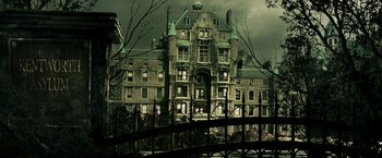 Movie still from “Punisher: War Zone” (2008), directed by Lexi Alexander – An old building with a fence in front of it; Extreme Wide shot, High angle