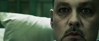 Movie still from “Punisher: War Zone” (2008), directed by Lexi Alexander – A man's face with a mustache; Extreme Close Up shot, Overhead angle