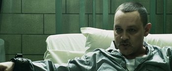 Movie still from “Punisher: War Zone” (2008), directed by Lexi Alexander – A man laying in a bed with pillows on top of him; Close Up shot, High angle