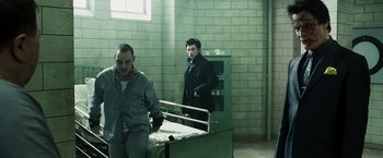 Movie still from “Punisher: War Zone” (2008), directed by Lexi Alexander – Two men standing next to each other in a room; Wide shot, Over the shoulder angle