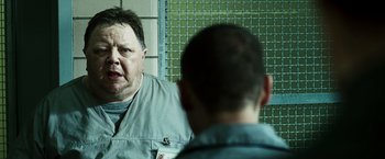 Movie still from “Punisher: War Zone” (2008), directed by Lexi Alexander – A man looking at himself in the mirror in front of a mirror; Close Up shot, Over the shoulder angle