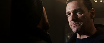 Movie still from “Punisher: War Zone” (2008), directed by Lexi Alexander – A man's face in a dark room; Close Up shot, Over the shoulder angle