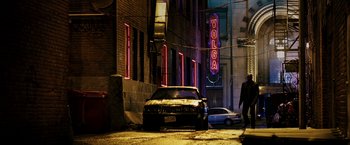 Movie still from “Punisher: War Zone” (2008), directed by Lexi Alexander – A car parked in the middle of a street at night; Wide shot, Low angle
