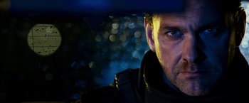 Movie still from “Punisher: War Zone” (2008), directed by Lexi Alexander – A man's face in the dark; Close Up shot, Over the shoulder angle