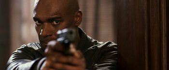 Movie still from “Punisher: War Zone” (2008), directed by Lexi Alexander – A person holding a gun; Close Up shot, Low angle