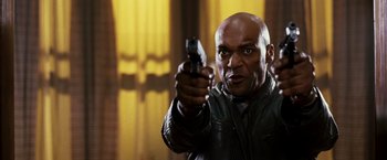 Movie still from “Punisher: War Zone” (2008), directed by Lexi Alexander – A bald man holding a gun in his hand; Close Up shot, Low angle