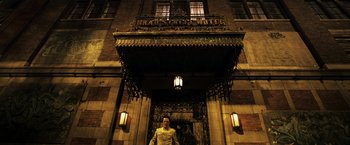 Movie still from “Punisher: War Zone” (2008), directed by Lexi Alexander – A man standing in front of a building at night; Wide shot, Low angle