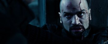 Movie still from “Punisher: War Zone” (2008), directed by Lexi Alexander – A person with a scar on his face; Close Up shot, Low angle