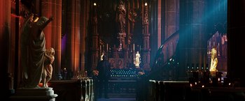 Movie still from “Punisher: War Zone” (2008), directed by Lexi Alexander – A man standing in front of a pipe organ in a church; Extreme Wide shot, High angle
