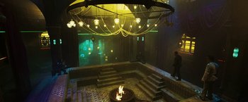 Movie still from “Punisher: War Zone” (2008), directed by Lexi Alexander – A fire pit in the middle of a room with lights; Extreme Wide shot, High angle