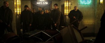 Movie still from “Punisher: War Zone” (2008), directed by Lexi Alexander – A group of people standing in a room; Wide shot, Low angle