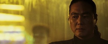 Movie still from “Punisher: War Zone” (2008), directed by Lexi Alexander – A man in a black jacket is looking at the camera; Close Up shot, Low angle