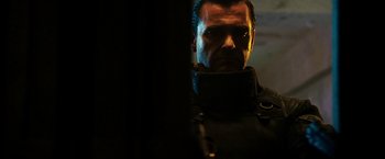 Movie still from “Punisher: War Zone” (2008), directed by Lexi Alexander – A person wearing a suit and tie; Close Up shot, Low angle