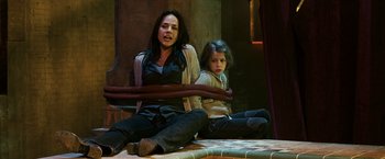 Movie still from “Punisher: War Zone” (2008), directed by Lexi Alexander – A woman sitting next to a little girl; Medium shot, High angle