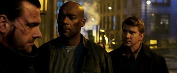 Movie still from “Punisher: War Zone” (2008), directed by Lexi Alexander – A man in a leather jacket standing next to another man in a leather jacket; Close Up shot, Low angle