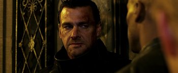 Movie still from “Punisher: War Zone” (2008), directed by Lexi Alexander – A person wearing a black jacket; Close Up shot, Low angle