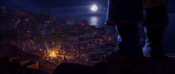 Movie still from “Puss in Boots” (2011), directed by Chris Miller – A crowd of people standing around a bonfire; Extreme Wide shot, High angle