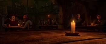 Movie still from “Puss in Boots” (2011), directed by Chris Miller – A lit candle sitting on top of a wooden table in front of people; Wide shot, High angle