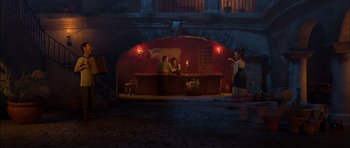 Movie still from “Puss in Boots” (2011), directed by Chris Miller – Two people sitting at a bar with a woman standing in front of them; Wide shot, Over the shoulder angle