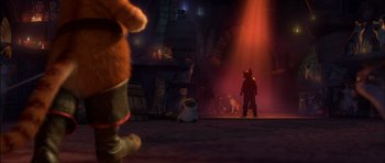 Movie still from “Puss in Boots” (2011), directed by Chris Miller – A scene with a cat and a dog in the background; Wide shot, Over the shoulder angle