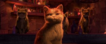 Movie still from “Puss in Boots” (2011), directed by Chris Miller – An orange and white cat sitting on top of a wooden table; Close Up shot, Low angle