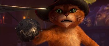 Movie still from “Puss in Boots” (2011), directed by Chris Miller – An orange cat wearing a black hat and holding a knife; Close Up shot, Low angle