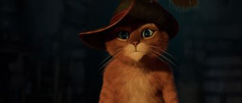 Movie still from “Puss in Boots” (2011), directed by Chris Miller – An orange cat wearing a brown hat with blue eyes; Close Up shot, Low angle