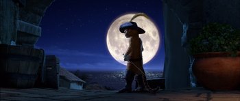 Movie still from “Puss in Boots” (2011), directed by Chris Miller – A cat wearing a hat and holding a sword in front of a full moon; Wide shot, Low angle