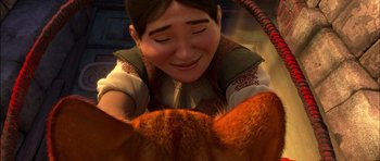 Movie still from “Puss in Boots” (2011), directed by Chris Miller – A woman is smiling next to an orange cat; Close Up shot, Low angle