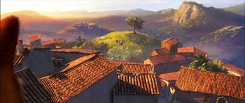 Movie still from “Puss in Boots” (2011), directed by Chris Miller – An aerial view of a town with a tree in the background; Extreme Wide shot, Low angle