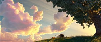 Movie still from “Puss in Boots” (2011), directed by Chris Miller – A person standing on a hill near a tree; Extreme Wide shot, Low angle